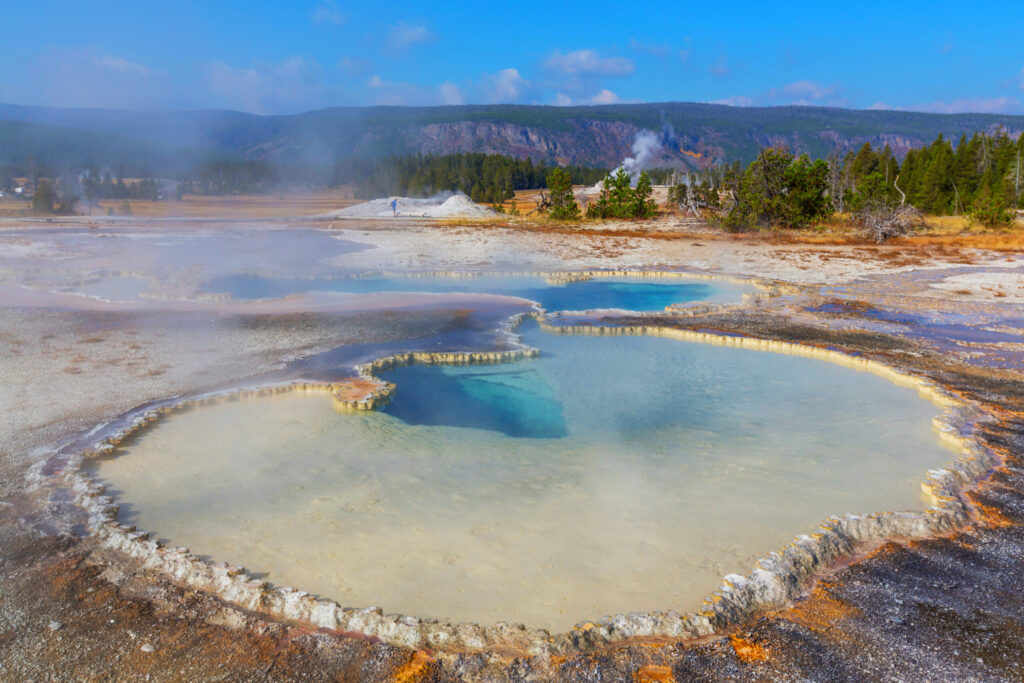 A drone shot of several geysers in Yellowstone National Park.
